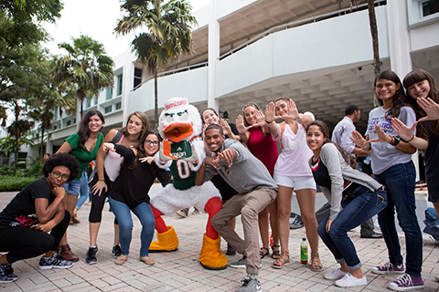 A group of students standing with Sebastian the Ibis