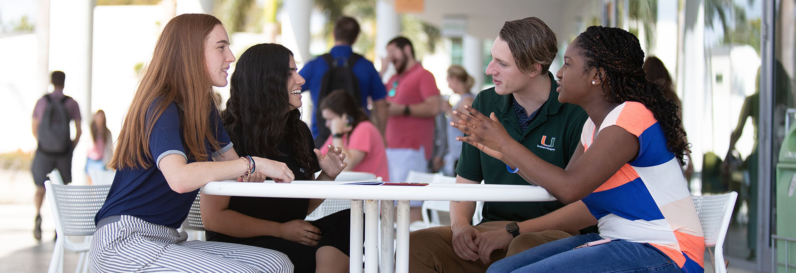 students talking at the shalala student center